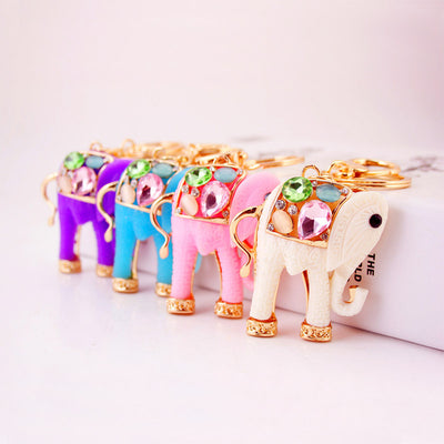 Pink, blue, purple, and white elephant keychains arranged in a row.
