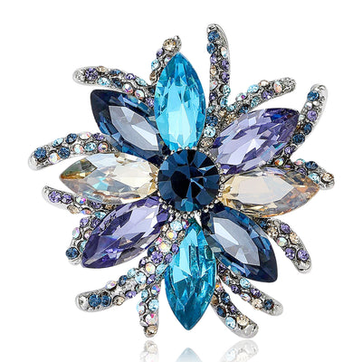 Front view showing the blue mixed crystal flower brooch with layered pointed petals