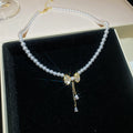 Pearl Strand Bow Pendant Necklace With Decorative Accents view 1