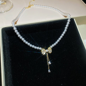 Pearl Strand Bow Pendant Necklace With Decorative Accents