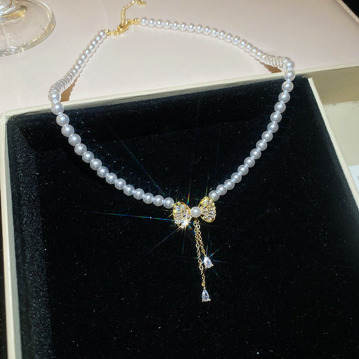 Pearl Strand Bow Pendant Necklace With Decorative Accents