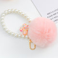 Pink Faux Fur Pom Keychain with Pearl Strand and Glitter Flower Charm view 4