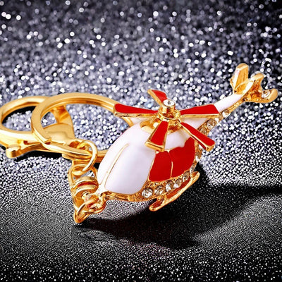 Main image 1 shows a supplied presentation of jeweled helicopter keychains with visible attached key hardware.