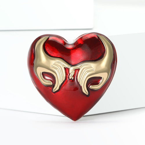 Red heart brooch close-up glossy enamel surface