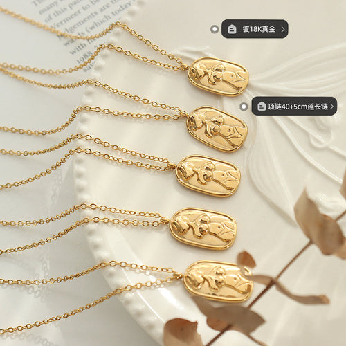 Five gold oval female torso pendants flat lay with size labels