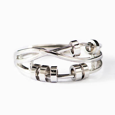 Silver multi-band infinity open ring with bead accents on white background