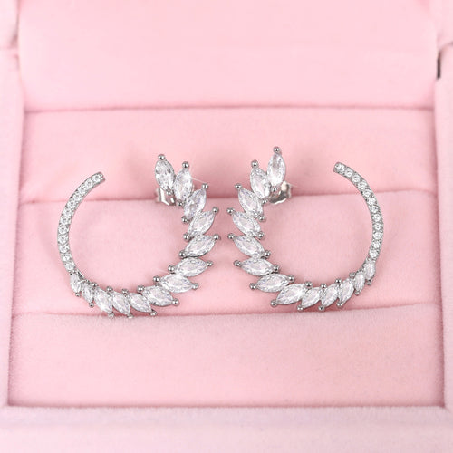 Silver tone leaf hoop earrings with clear marquise stones, pair shown from the front