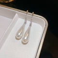 White Teardrop Dangle Earrings In Gold And Silver With Decorative Details view 7