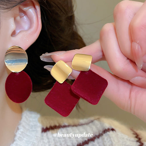 Styled wear view of gold-tone round studs with red velvet oval or diamond-shaped drops