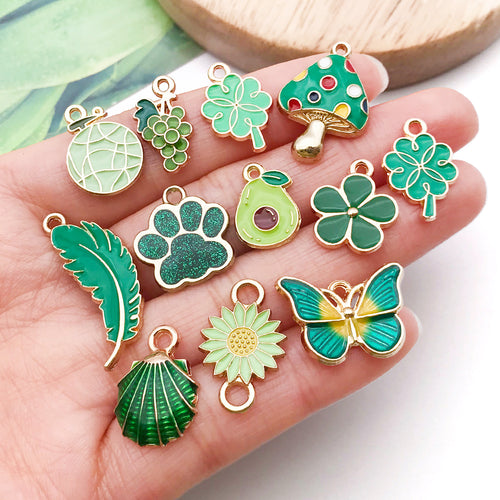 Green four-leaf clover and mushroom charms shown in a close-up product view