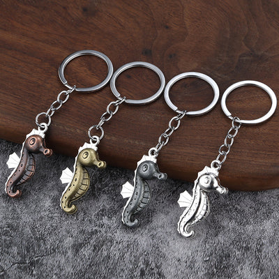 Four seahorse keychains in copper, bronze, dark silver, and bright silver finishes.