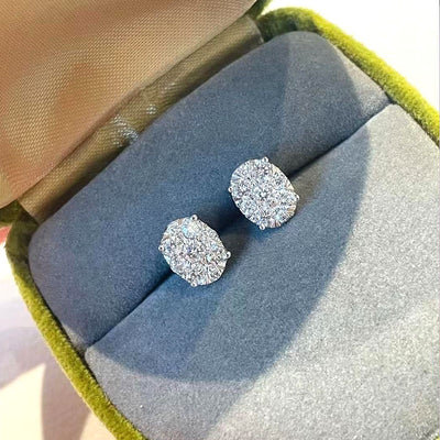 Cushion cluster clear-stone studs in a green box