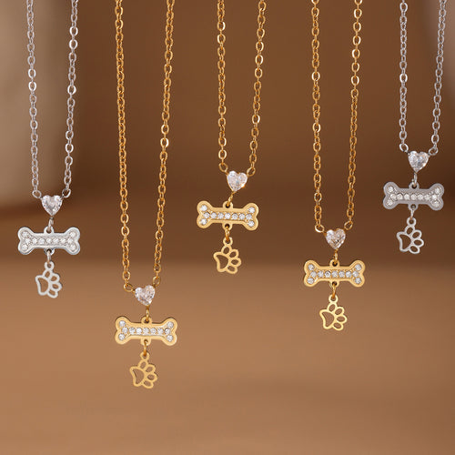 Gold and steel bone paw necklaces hanging display lineup