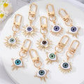 Gold Tone Sculpted Sun and Lash Realistic Eye Clip Keychains view 1