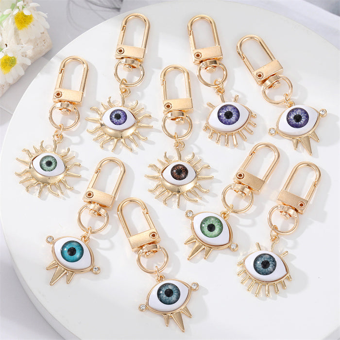 Gold Tone Sculpted Sun and Lash Realistic Eye Clip Keychains