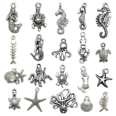 Metallic seahorse and turtle charms arranged on a light background
