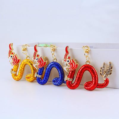 Gold, blue, and red dragon charms are lined up with gold-tone clasps.