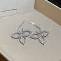 Open Flower Outline Stud Earrings in Gold and Silver view 7