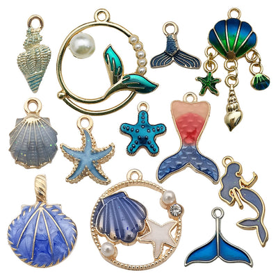 Colorful mermaid and starfish charms arranged on a light background