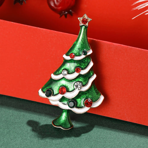 A green Christmas tree with white garland and red ornaments shown in a styled display.