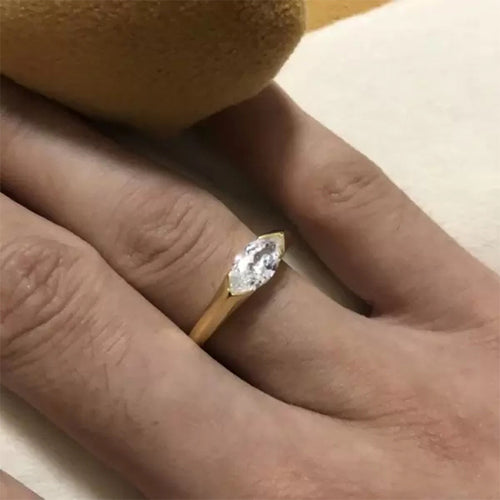 Second product view showing gold-tone flush-set marquise clear solitaire ring