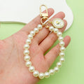 White Beaded Wristlet Keychain with Rose and Butterfly Charms view 2