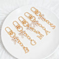 Gold Tone Initial Letter Bag Charm with Pastel Enamel Bow view 2