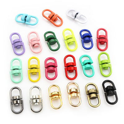 small oval swivel connector clasps arranged together on a white background