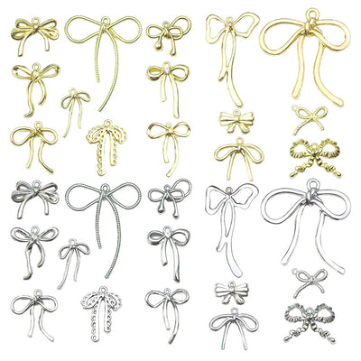 Metallic bow and butterfly charms arranged on a light background