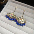 Blue Crystal Drop Earrings with Gold Tone Details in Two Designs view 2