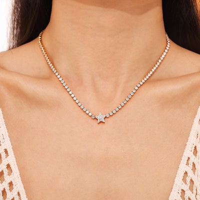 Gold tennis star necklace worn as a choker on model