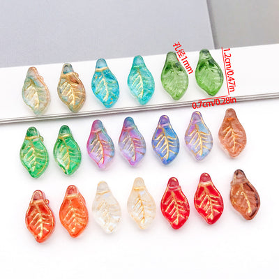 Mini glass leaf beads with through holes arranged as a full product overview