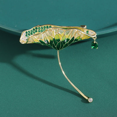 Green Lotus Leaf brooch styles arranged on a light display
