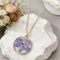 Gold Tone Round Pressed Flower Pendant Necklaces in Fourteen Designs view 3