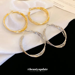 Polished Hoop Earrings In Gold And Silver With Decorative Details