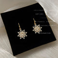 Clear CZ Snowflake Drop Earrings Gold Tone Fishhook Wires view 1