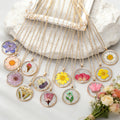 Gold Tone Round Pressed Flower Pendant Necklaces in Fourteen Designs view 1