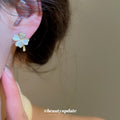 White Five-Petal Flower Stud Earrings with Polished Metal Details view 3