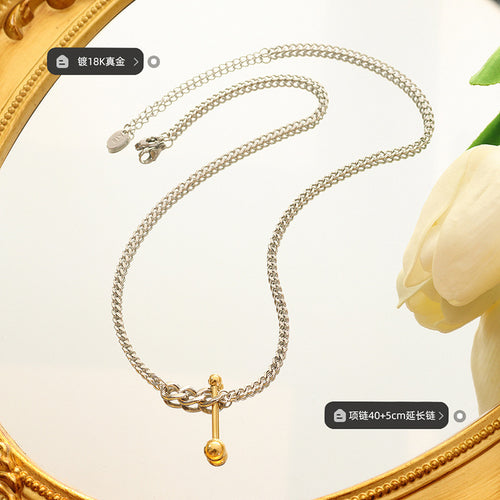 Steel curb gold U-bar necklace flat lay with printed labels