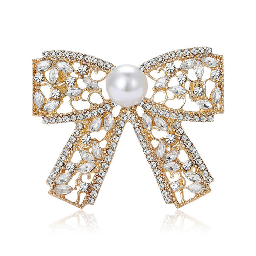 Front view of openwork ribbon bow centered by a single white pearl-like bead