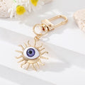Gold Tone Sculpted Sun and Lash Realistic Eye Clip Keychains view 6