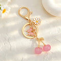 Cherry Charm Keychain with Enamel Butterfly and Daisy Flower Pendant view 4