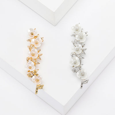 Front view of pearl blossom branch brooch with five flowers decorative metal pin