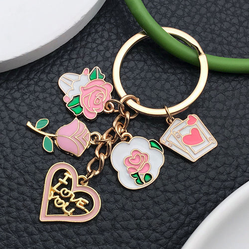 Alternate arrangement of the pink rose love heart letter and card metal keychain showing its hardware and charm details