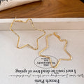 Large Open Star Hoop Earrings in Gold and Silver Tones view 7