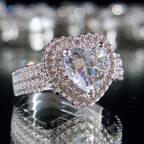 Angled detail of heart halo stone ring