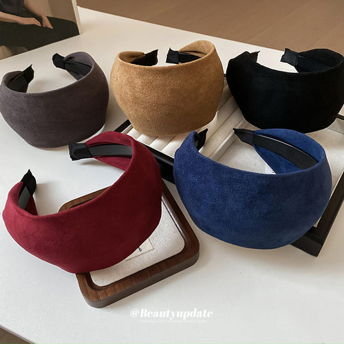 black wide suede-like padded headband with an unlisted color assortment shown worn in a styled second view