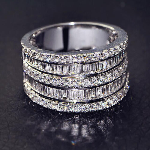 White gold five-row baguette and round pave wide band on dark surface