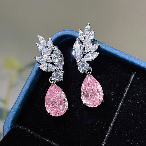 Pink pear drop leaf crystal earrings on blue velvet tray