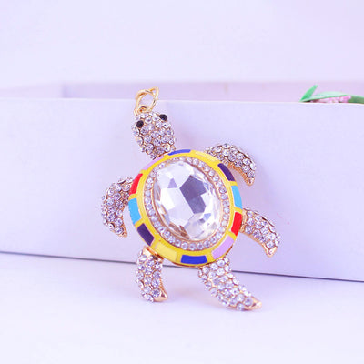 Front view of a sea turtle charm with clear rhinestones and multicolor shell accents.